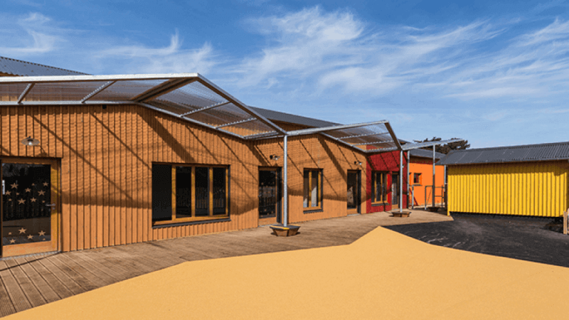 A daycare with bright colors on the exterior of each separate building.