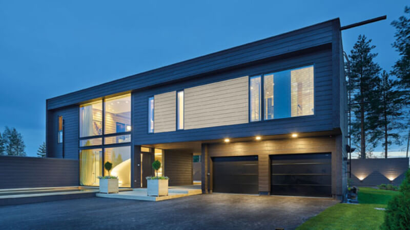 A modern styled house with wood paneling finished with exterior wood finish.