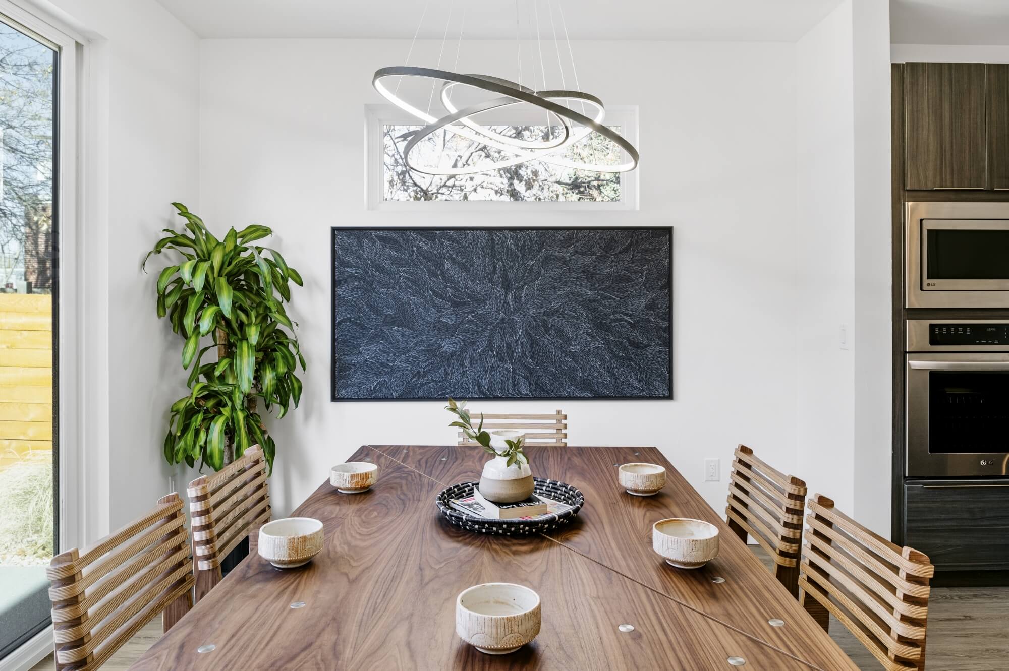 Beautiful walnut dining table staged in a modern dining room.