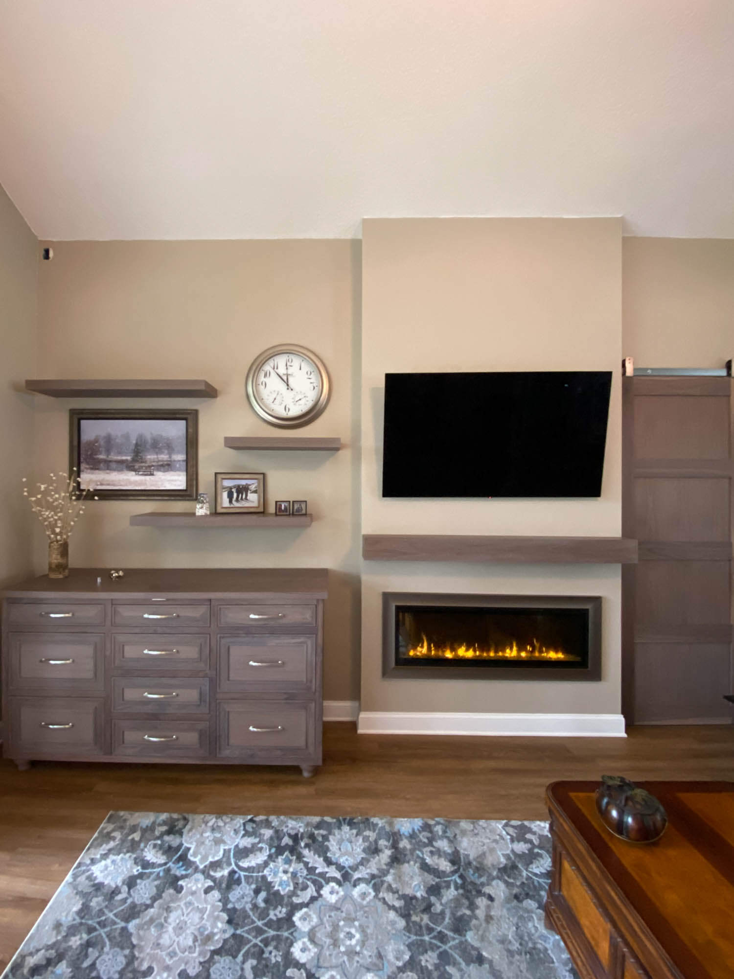 Solid walnut buffet with matching floating shelves, mantle, and barn door finished with Rubio Monocoat products.