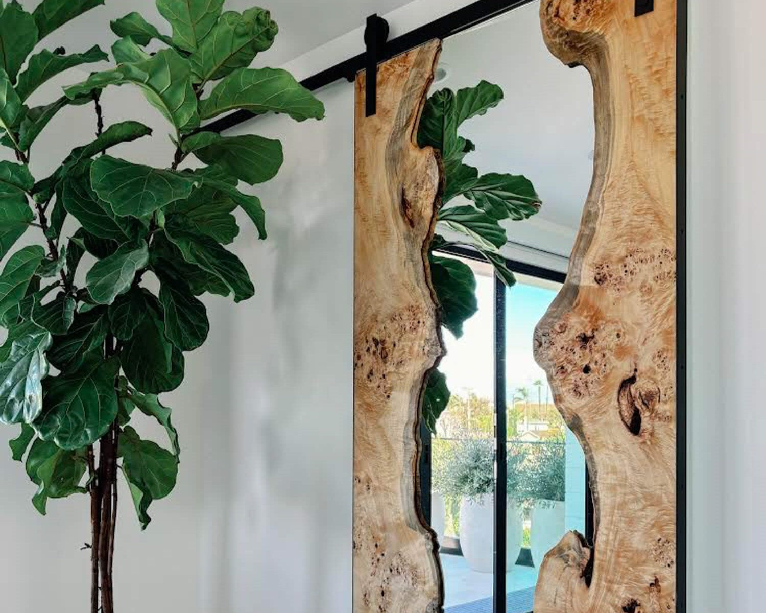 Modern sliding barn door inspiration made from two mappa burl slabs and a mirror. The wood was finished with Rubio Monocoat Oil Plus 2C hardwax oil for interior wood surfaces.