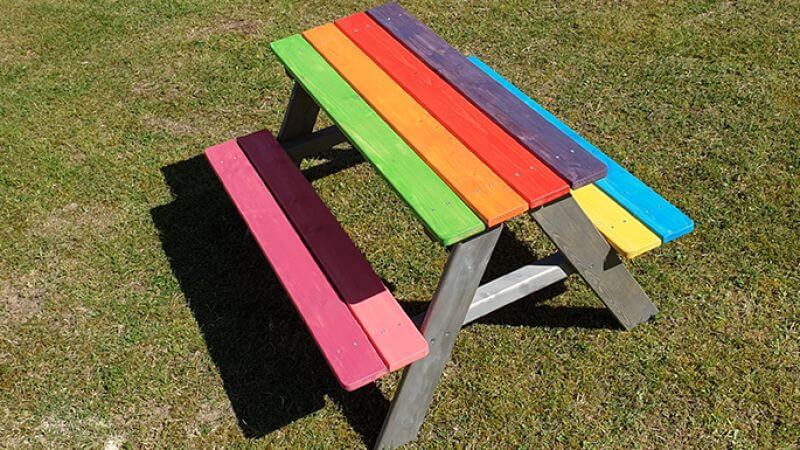 Colorful kids picnic bench made with wood finished with Rubio Monocoat.