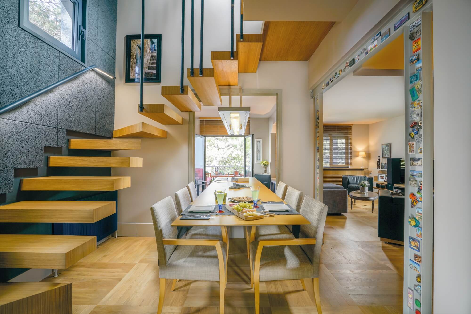 Home office with parquet floors and a staircase winding upstairs.