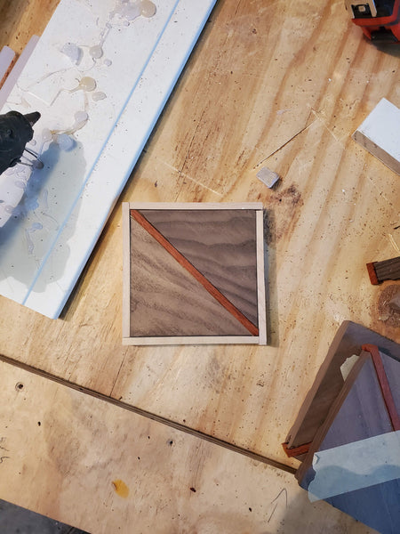 Walnut, maple and bubinga squares apart of a basketweave floor pattern.