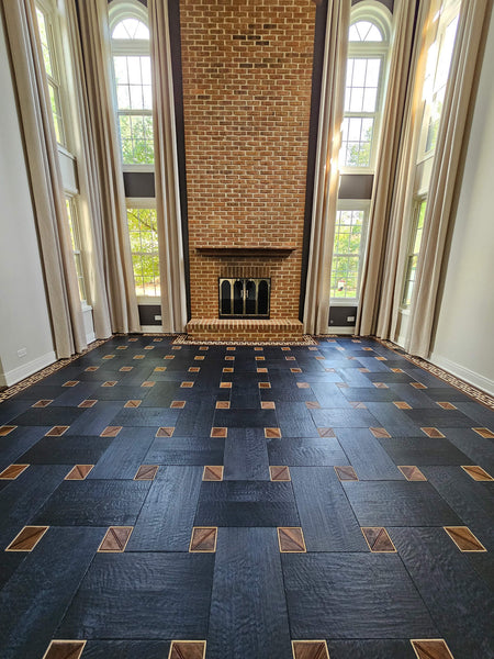 A custom white oak basketweave floor with hand finished squares made from maple, walnut, and bubinga woods finished using Rubio Monocoat products.