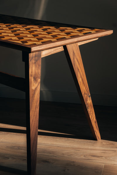 Made from walnut wood, this contemporary desk features a modern geometric inlay.