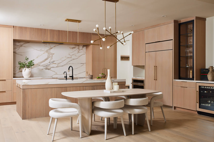 A contemporary kitchen with floor-to-ceiling white oak cabinetry and modern elements throughout.