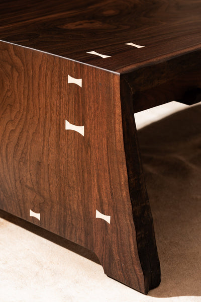 A waterfall edge on a walnut coffee table that also has maple bowties. It was finished with Oil Plus 2C Pure hardwax oil wood finish.